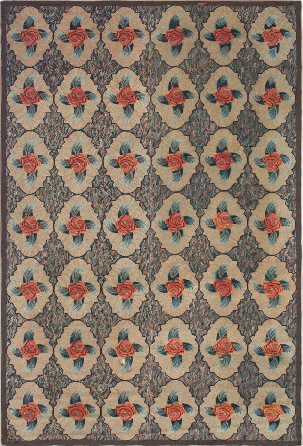 Golden floral rug with orange roses, green leaves, and calibration cards resting on light wooden flooring.