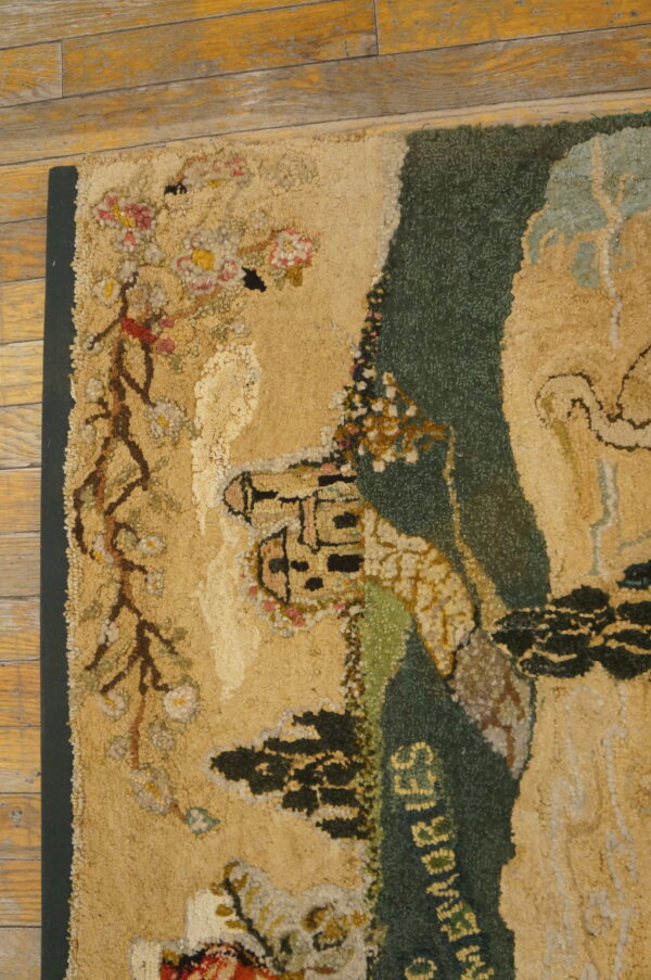 High-pile rug with a beige and dark green scenic pattern including the word memories on worn wood flooring.