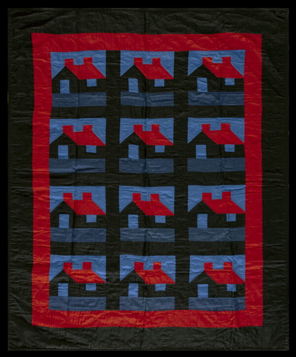 Black, red, and blue textile featuring a repeated house pattern inside thick red and black borders.