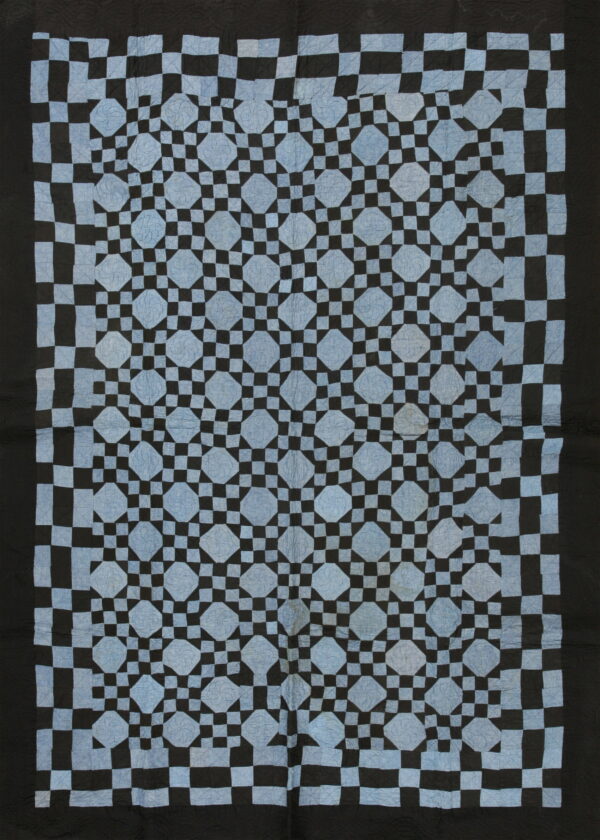 Full-length black and light blue geometric rug featuring large diamond shapes surrounded by a small checkerboard grid.