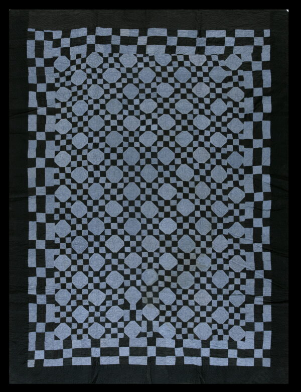 Slate blue and black textile featuring a repeating geometric star and lattice pattern with a wide solid border.