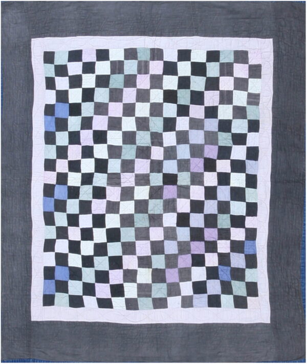 Square patchwork rug with a multicolored pastel and dark gray checkerboard field and quilted solid gray borders.