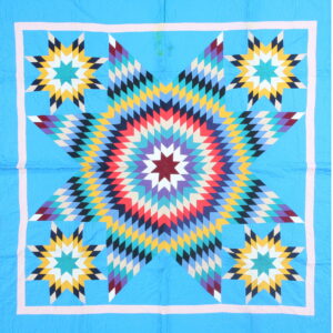 Blue textile with a radiating central star pattern in red, yellow, purple, teal, and black diamonds.