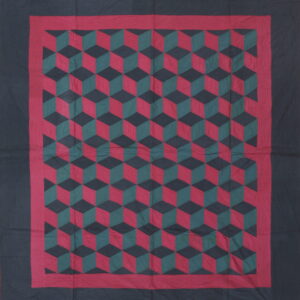 Flat textile rug featuring a red, green, and black geometric tumbling block pattern with dark borders.