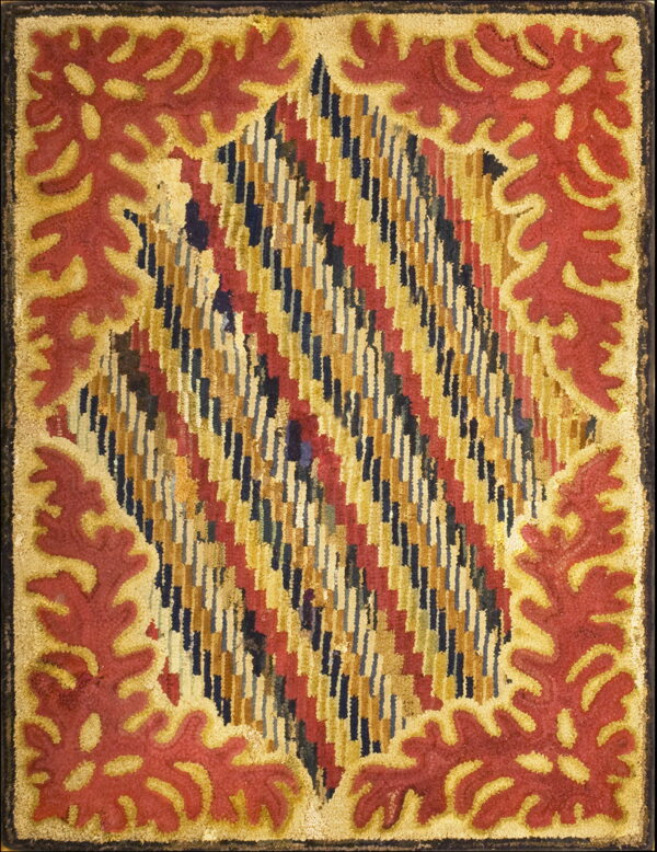 Highly textured rug displaying a central multi-color diagonal design framed by a bold red and gold leafy border.