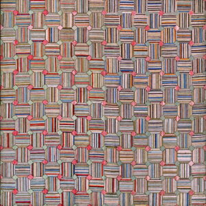 A colorful patchwork-style rug with striped octagonal blocks connected by pink and sage geometric shapes.