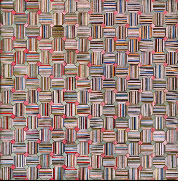 A colorful patchwork-style rug with striped octagonal blocks connected by pink and sage geometric shapes.