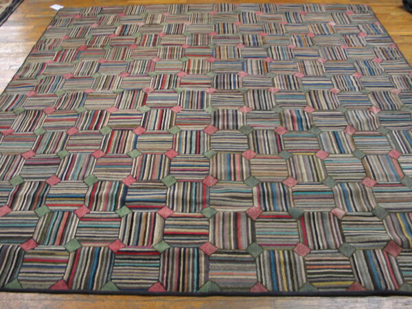 High-pile rug with a checkered pattern of multicolored striped blocks and pink and green accents on a wood floor.