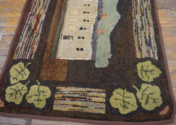 Rustic hooked rug with dark brown border, green leaves, and abstract beige architecture on distressed wood floors.