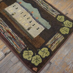 Hooked rug featuring a beige apartment building, blue water, and green leaves on rustic hardwood flooring.