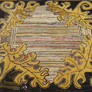 Black and gold rug featuring acanthus leaves and a multicolored striped center lies on wood flooring.