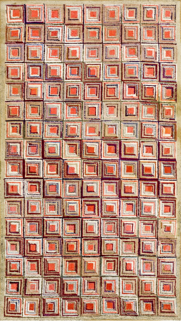 Textured rug displaying a geometric pattern of red-orange, beige, white, and multicolored concentric squares.