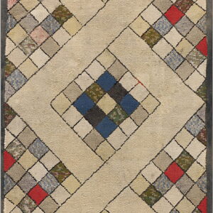Textured rug with a cream diamond pattern surrounding multicolored squares in red, blue, green, and gray.