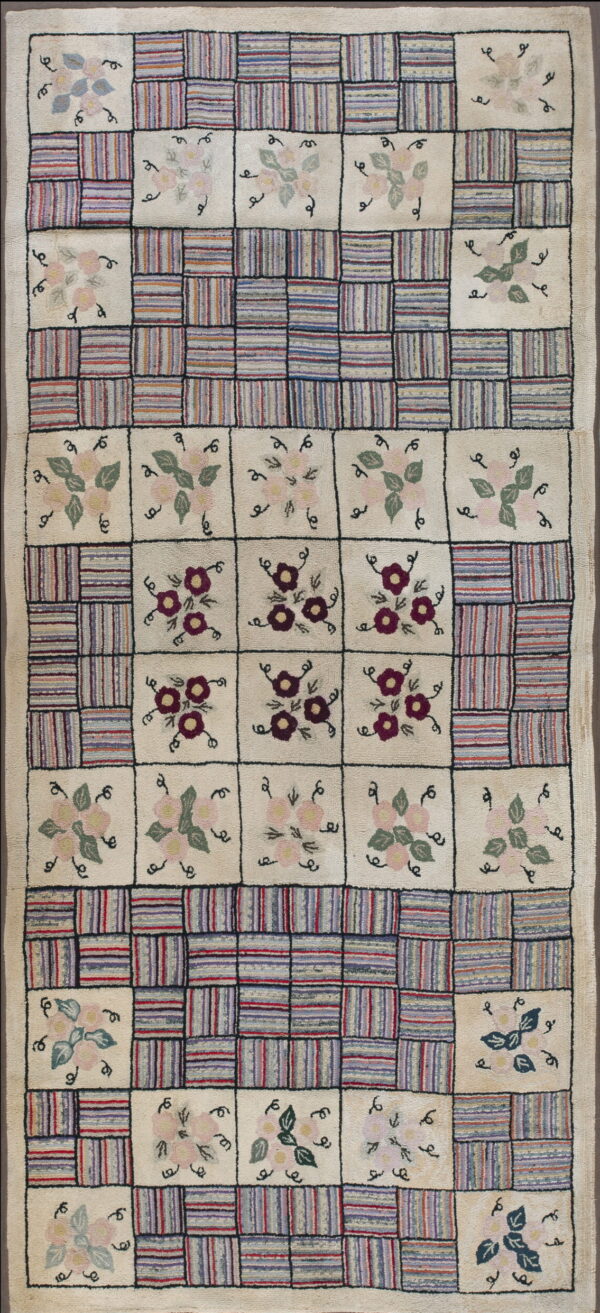 Hooked rug featuring an ivory checkerboard design with colorful striped blocks and stylized floral motifs.