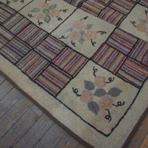 Textured patchwork rug featuring floral squares and striped multicolored block sections on weathered wood planks.