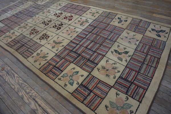 Cream checkerboard rug with floral designs and textured multicolored stripe squares, laid on weathered wood planks.