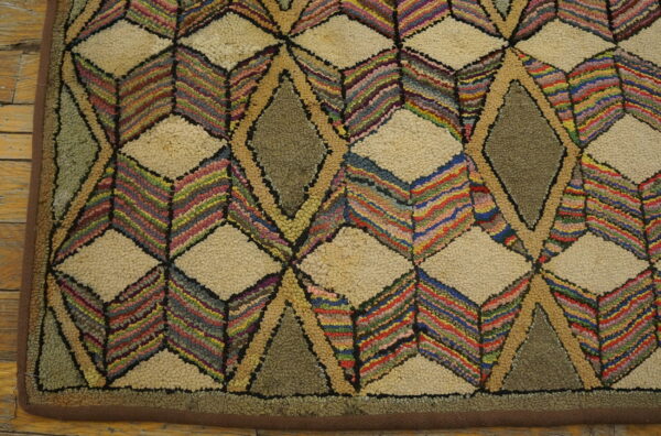 A highly textured rug featuring geometric diamond patterns in cream, olive, and multicolored stripes on wood flooring.