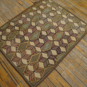 Multicolored striped and solid green geometric cube pattern rug sits upon rustic, worn wood planks.
