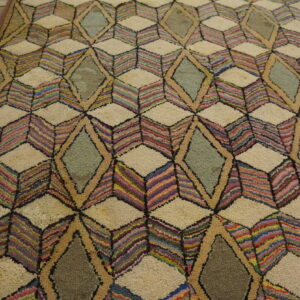 High-pile rug featuring multicolored striped cubes and sage diamonds on a rustic wood floor.