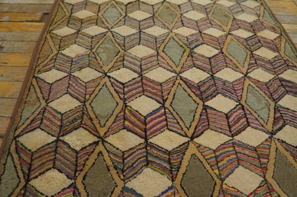 High-pile rug featuring multicolored striped cubes and sage diamonds on a rustic wood floor.