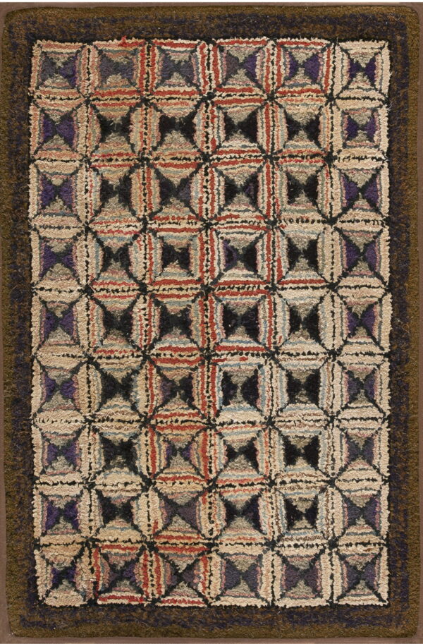 Highly textured rug displaying a multi-colored geometric block pattern framed by a wide dark olive border.
