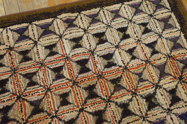 Shaggy, multicolor rug featuring interlocking geometric designs sits on a distressed wood floor.
