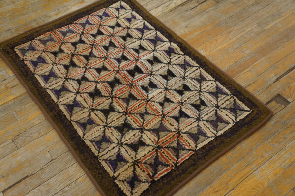 A textured rug with a multicolored diamond lattice in cream, rust, and purple sits on distressed wood planks.