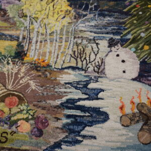 High-pile multicolor rug with detailed seasonal scenes, including a snowman and cornucopia, beside wood flooring.