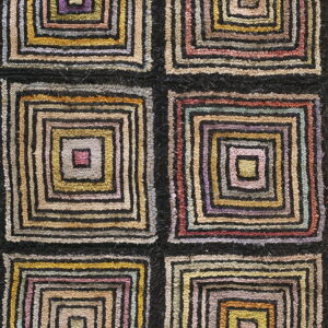 High-pile rug featuring a grid of six blocks with black lines and multicolored concentric squares.