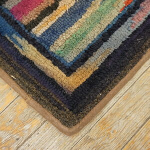 Colorful vintage hooked rug corner