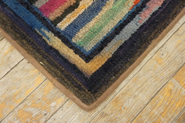 Colorful vintage hooked rug corner