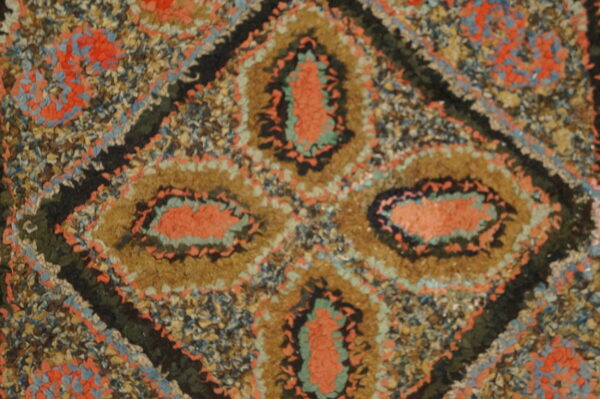 Colorful antique hooked rug design.