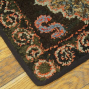 Colorful patterned antique hooked rug