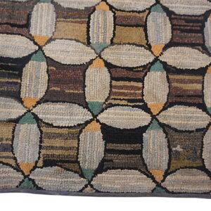 Geometric high-pile rug featuring large light beige interlocking ovals and dark brown striped square shapes.