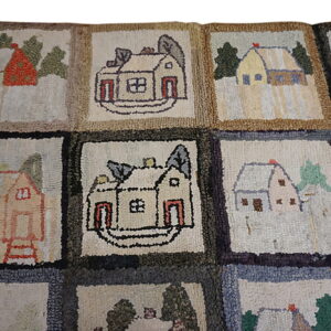 High-pile, patched rug featuring a repeating grid pattern of colorful, rustic houses and scenery.