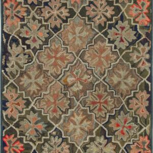 Muted olive and orange floral pattern runner displayed on distressed grey and yellow wood floors next to rolled rugs.