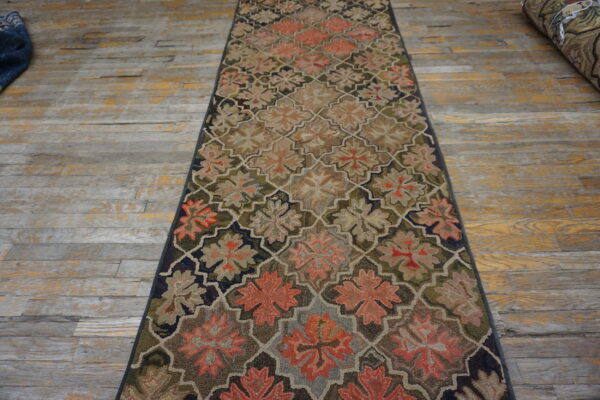 Highly textured runner rug with a quatrefoil floral pattern in muted coral, tan, and olive green.