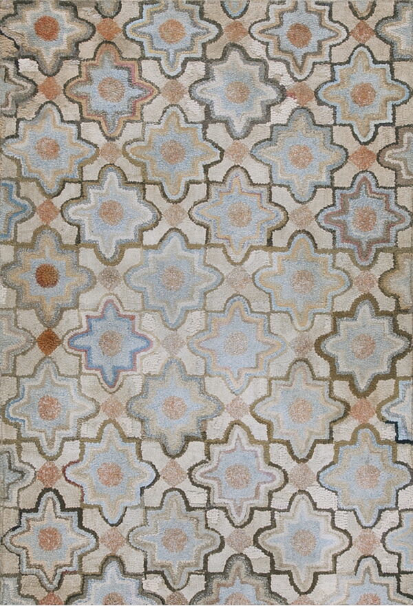 Textured rug featuring a geometric pattern of blue and rust star shapes framed by brown lines on a light beige field.