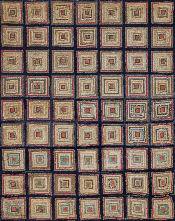 Low-pile rug with a grid of multicolored concentric squares sits on weathered gray wood flooring.