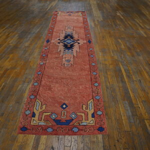 Colorful vintage rug on wooden floor.