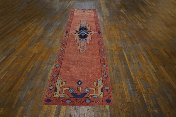 Colorful vintage rug on wooden floor.