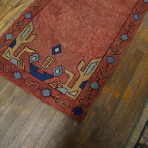 Colorful vintage rug on wooden floor.