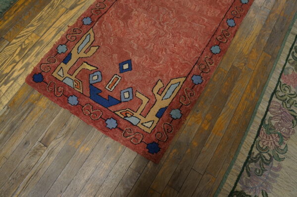Colorful vintage rug on wooden floor.