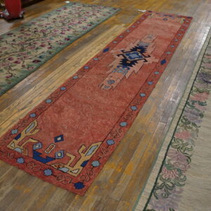 Three colorful rugs on wooden floor.