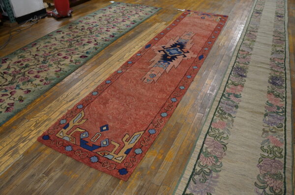 Three colorful rugs on wooden floor.