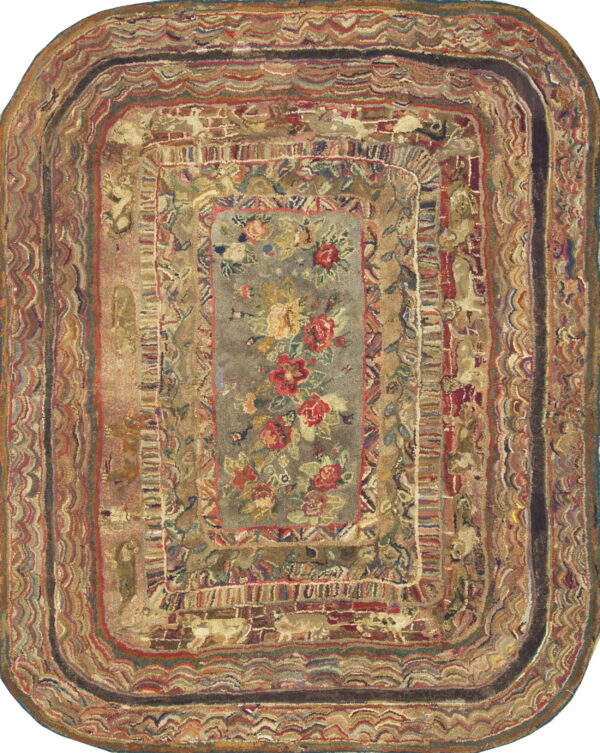 Hooked oblong rug in rich earthy colors with a floral center surrounded by detailed concentric striping.