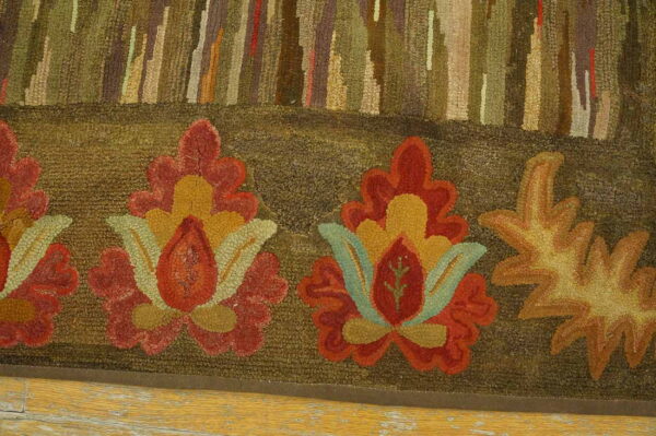 High-pile, earth-toned rug displays abstract forest and large autumnal floral patterns over yellow wood flooring.