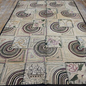 Muted beige textured rug with a black border, showing squares filled with geometric, circular, and folk art designs.