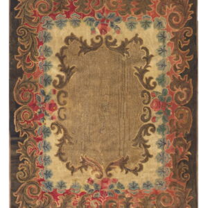 Ornate traditional rug with a tan center, dark border, and red, blue, and brown scrolling floral detailing.