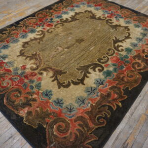 Ornate dark, red, and blue floral rug with a striated khaki center rests on weathered wood planks.